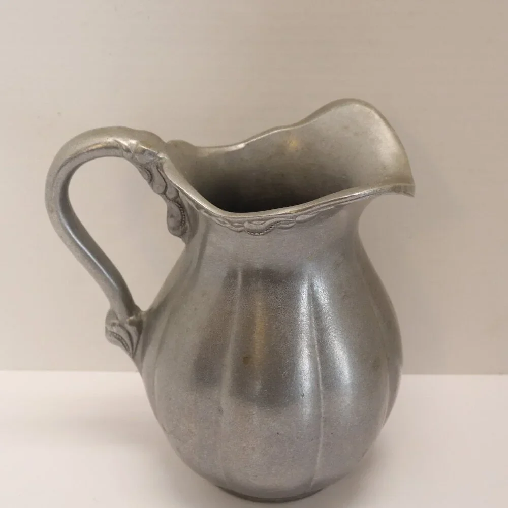 A Heavy Pewter Water Pitcher Pre Owner with some signs of wear